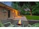 Brick home's backyard features a patio, fire pit, a well maintained lawn and mature trees at 10844 W 68Th Ave, Arvada, CO 80004