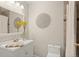 Bright bathroom featuring a vanity with a white countertop, a large mirror, and tiled walls at 10844 W 68Th Ave, Arvada, CO 80004