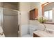 Bathroom features updated vanity, wainscoting, and walk-in shower at 10844 W 68Th Ave, Arvada, CO 80004