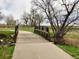 A pathway and wooden bridge winds through a scenic natural landscape and neighborhood at 10844 W 68Th Ave, Arvada, CO 80004