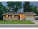 Charming ranch home features a well-manicured front lawn, brick facade, and attached one-car garage at 10844 W 68Th Ave, Arvada, CO 80004
