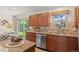 Updated kitchen featuring stainless steel appliances, tiled backsplash, and access to the backyard at 10844 W 68Th Ave, Arvada, CO 80004