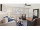 Bright living room featuring stylish furniture, decorative rug, and natural light from the window at 10844 W 68Th Ave, Arvada, CO 80004