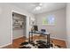 Bright office featuring hardwood floors, a window with white shutters, and built-in shelves at 10844 W 68Th Ave, Arvada, CO 80004