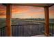 Balcony view showing trees and landscape at dusk at 8700 Lost Lake Dr, Franktown, CO 80116