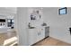 Modern bar area with white cabinets, stylish shelving, and sleek countertops at 8700 Lost Lake Dr, Franktown, CO 80116