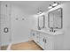 Modern bathroom features double vanity with white countertops, sleek mirrors, and a glass-enclosed shower at 8700 Lost Lake Dr, Franktown, CO 80116