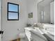 Bright bathroom with a modern vanity, stylish fixtures, and a window overlooking a scenic view at 8700 Lost Lake Dr, Franktown, CO 80116