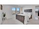 Bright bedroom featuring two windows with scenic views, a dark wood bed frame, and neutral-toned carpet at 8700 Lost Lake Dr, Franktown, CO 80116