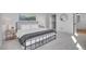 Bedroom with a black metal bed frame, soft gray carpeting, and an adjacent bathroom at 8700 Lost Lake Dr, Franktown, CO 80116