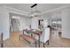 Dining area boasts hardwood flooring, a modern chandelier, and seamless flow to other living spaces at 8700 Lost Lake Dr, Franktown, CO 80116