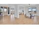 Dining room with hardwood floors, dining table, a modern light fixture and view of the living room at 8700 Lost Lake Dr, Franktown, CO 80116