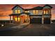 Charming front elevation with stone accents, covered porch, and an attached garage at 8700 Lost Lake Dr, Franktown, CO 80116