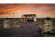 Elegant two-story house with stone columns, asphalt drive and an American flag at 8700 Lost Lake Dr, Franktown, CO 80116