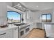 Modern kitchen features a large island, stainless steel appliances, ample counter space, and scenic outdoor views at 8700 Lost Lake Dr, Franktown, CO 80116