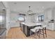 Modern kitchen with white cabinetry, stainless steel appliances, a large island, and scenic outdoor views at 8700 Lost Lake Dr, Franktown, CO 80116