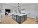 Bright kitchen with white countertops, a large kitchen island and a view of the living room at 8700 Lost Lake Dr, Franktown, CO 80116