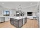 Bright kitchen with white countertops, stainless steel appliances, a large kitchen island, and open floorplan at 8700 Lost Lake Dr, Franktown, CO 80116