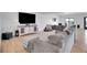 Cozy living room with large gray sectional, media console, and a modern design at 8700 Lost Lake Dr, Franktown, CO 80116