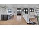 Open living area with hardwood floors, comfortable seating, modern fireplace, and access to outdoor living spaces at 8700 Lost Lake Dr, Franktown, CO 80116