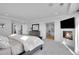 Spacious main bedroom suite featuring a fireplace, TV, and a glimpse into the luxurious bathroom at 8700 Lost Lake Dr, Franktown, CO 80116