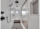 Modern shower featuring sleek fixtures, a tiled bench, and glass door at 8700 Lost Lake Dr, Franktown, CO 80116