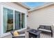Inviting back deck with a cozy seating area and sliding glass door access to the home's interior at 509 High Point Dr, Longmont, CO 80504