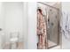 Clean bathroom features a glass shower enclosure, toilet, and is freshly painted at 509 High Point Dr, Longmont, CO 80504