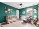Comfortable Bedroom with crib, rocking chair, and natural light at 509 High Point Dr, Longmont, CO 80504