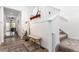 Inviting entryway featuring modern decor, a charming bench and access to the staircase with natural light at 509 High Point Dr, Longmont, CO 80504