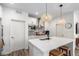 Well-lit kitchen with white cabinets, quartz countertops, a large island with seating, and stainless appliances at 509 High Point Dr, Longmont, CO 80504