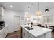 Bright, modern kitchen with a large island, stainless steel appliances, and an open layout to the living room at 509 High Point Dr, Longmont, CO 80504