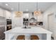 Modern kitchen with white cabinetry, stainless steel appliances, a large island and stylish pendant lighting at 509 High Point Dr, Longmont, CO 80504