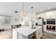 Bright kitchen features a large island, stainless appliances, eat in dining area, and modern lighting fixtures at 509 High Point Dr, Longmont, CO 80504