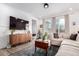 Comfortable living room featuring a large sectional sofa, modern decor, and ample natural light from large windows at 509 High Point Dr, Longmont, CO 80504