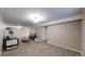 Finished basement with neutral carpet, modern furniture, and ample space at 11813 Bellaire Cir, Thornton, CO 80233