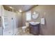 Bathroom features a tiled shower, modern vanity, and neutral decor at 11813 Bellaire Cir, Thornton, CO 80233