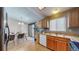 Functional kitchen featuring wooden cabinets, modern appliances, and a door to the outside area, perfect for outdoor dining at 11813 Bellaire Cir, Thornton, CO 80233