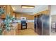 Spacious kitchen featuring updated appliances, light wooden cabinets, and ample countertop space for all your cooking needs at 11813 Bellaire Cir, Thornton, CO 80233