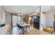 Dining area with a table set for six, in an open-concept layout with a kitchen with light wood cabinets at 11813 Bellaire Cir, Thornton, CO 80233