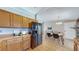 Well-equipped kitchen with wood cabinets, stainless steel appliances, and a dining area at 11813 Bellaire Cir, Thornton, CO 80233
