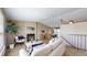 Cozy living room featuring a fireplace, comfortable seating, and a view of the dining area at 11813 Bellaire Cir, Thornton, CO 80233