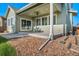 Covered outdoor patio with stone landscaping in a private backyard setting at 14035 Touchstone St, Parker, CO 80134