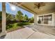 Back patio area under a covered roof, with an open view of the green backyard at 14035 Touchstone St, Parker, CO 80134