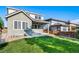 Home with green lawn, landscaping, and patio at 14035 Touchstone St, Parker, CO 80134