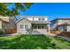 A lush green backyard and a home featuring a covered patio at 14035 Touchstone St, Parker, CO 80134