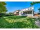 Well-maintained green backyard with a home featuring a covered patio at 14035 Touchstone St, Parker, CO 80134