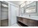 Bright bathroom with double sink vanity, sliding glass shower door, and neutral decor at 14035 Touchstone St, Parker, CO 80134