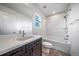 Bathroom with a single sink vanity, tub, and shower combination featuring white tiling at 14035 Touchstone St, Parker, CO 80134