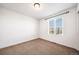 Bright bedroom with natural light, neutral carpeting, and fresh white walls at 14035 Touchstone St, Parker, CO 80134